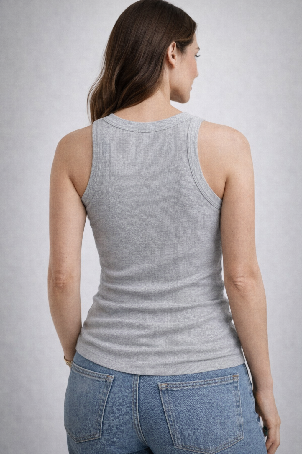 Female model wearing a gray tank top.